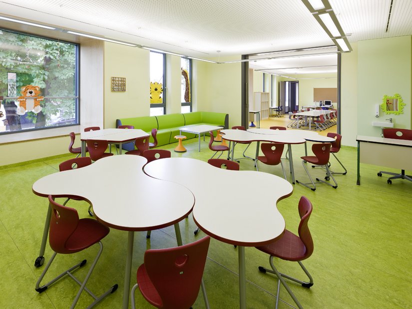 Nelle classi dominano tonalità decise di verde e rosso. Grazie alla loro speciale forma geometrica, i tavoli possono essere utilizzati in tante maniere diverse durante le lezioni.